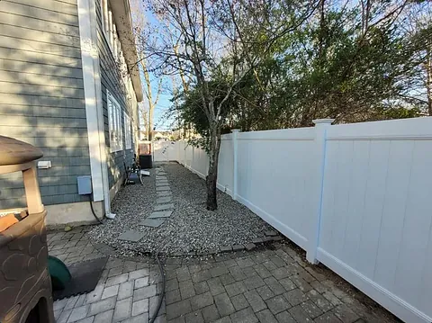 A new white fence secures a house
